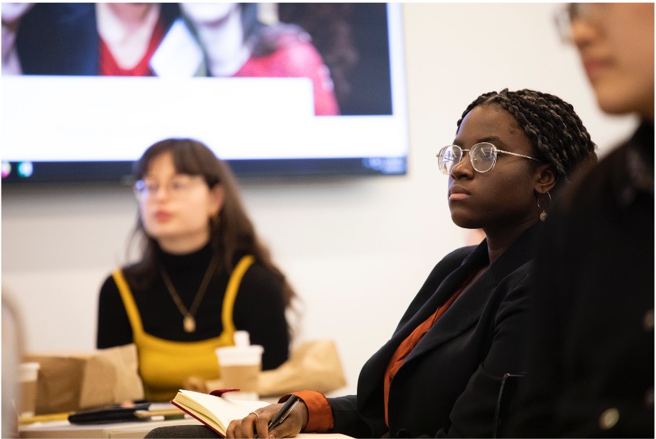 Barnard students in a panel discussion listening to a speaker