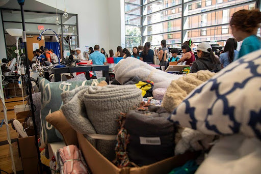 Image of donations and people shopping at the green sale