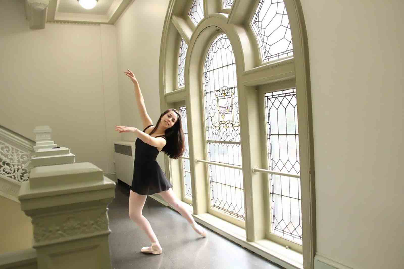 Young woman dancing near staircase