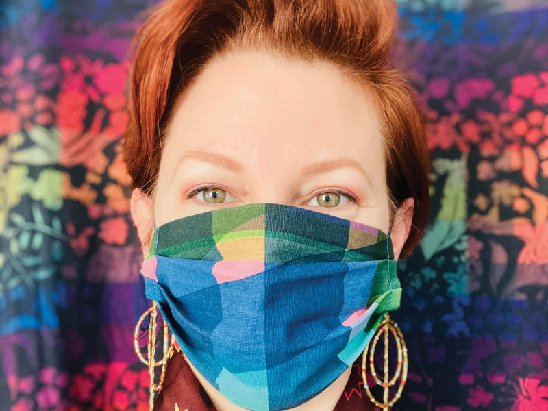 A woman wearing a colorful fabric mask