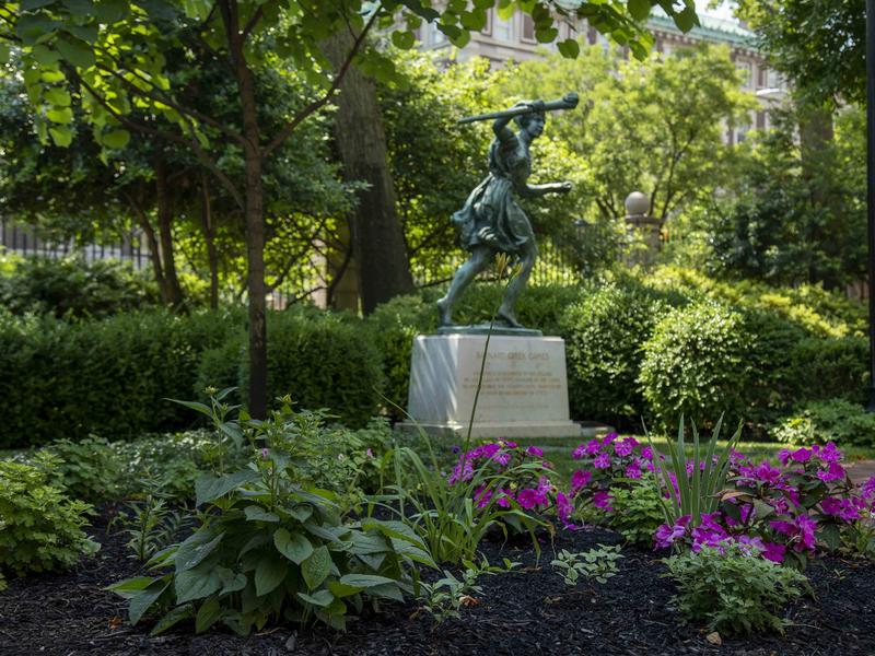 Barnard runner statue on campus in summer